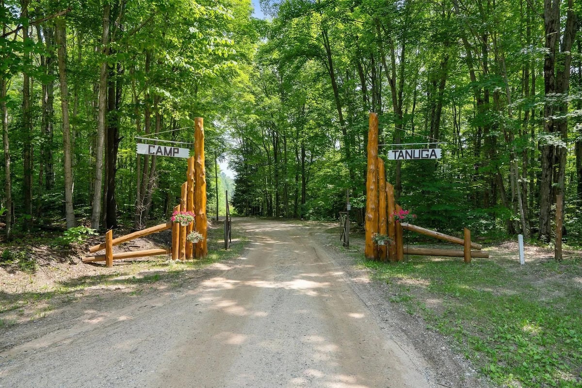 Camp Tanuga entrance between wooded grounds
