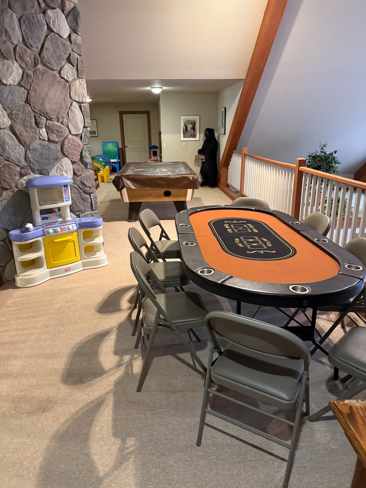 Upstairs recreation space with a pool table and game table