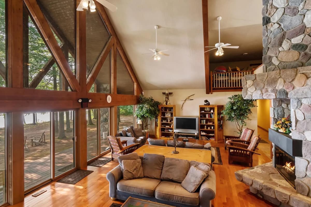 Vaulted lodge living room with seating and large windows